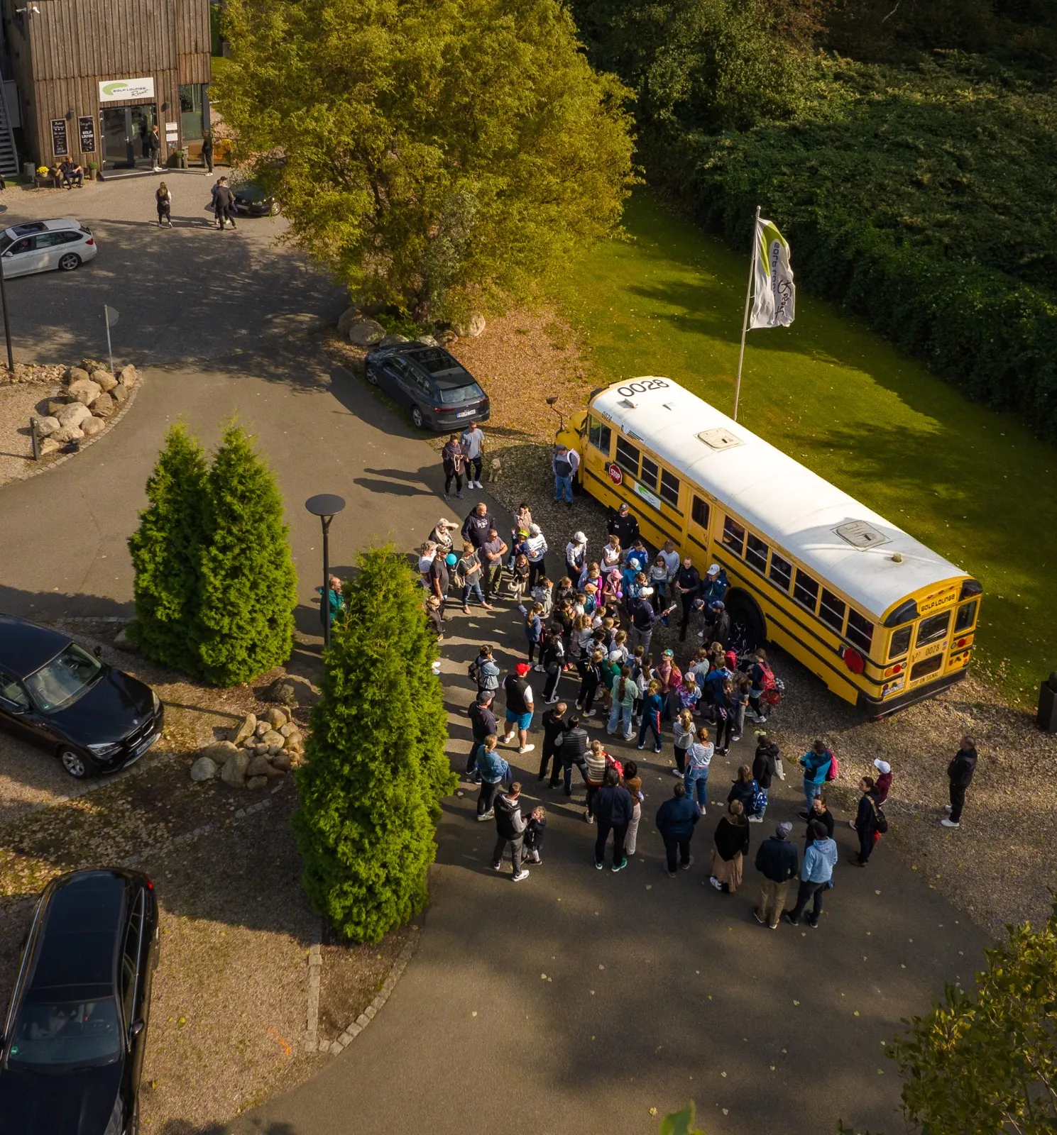 Participants of Golf Like a Girl event in front of shuttle bus